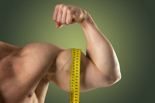 Man's strong arm with measuring tape isolated