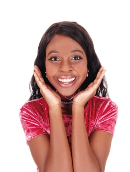 A closeup portrait of a African woman in a pink dress with her hands on.her face, smiling, isolated for white background.