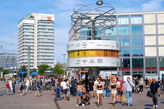 Tourists and residents at the World Clock at Alexanderplatz in Berlin-Mitte