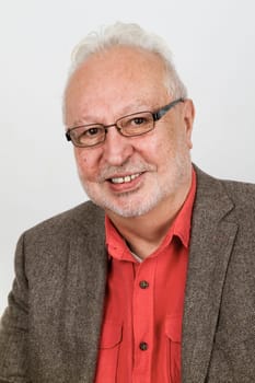 Portrait of friendly laughing senior on a bright background