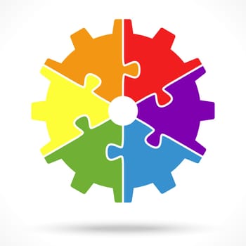 gear wheel with six colored puzzle parts for cooperation or teamwork symbolism