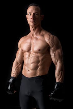 Strong Mixed Martial Arts fighter isolated in black