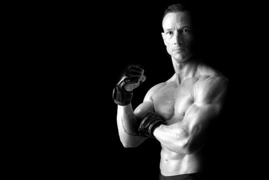 Strong Mixed Martial Arts fighter isolated in black