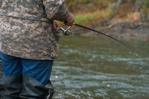 Fisherman at the Altai river, closeup photo