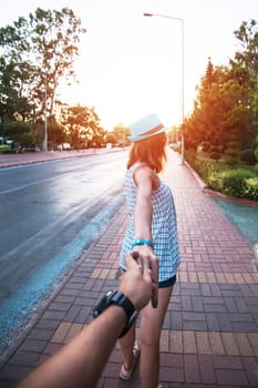 Girl holding a hand man on the street in city Alanya, Turkey