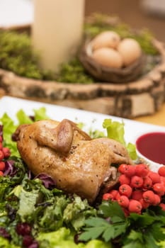 quail roasted with sweet and sour cranberry sauce decorated with rowanberry