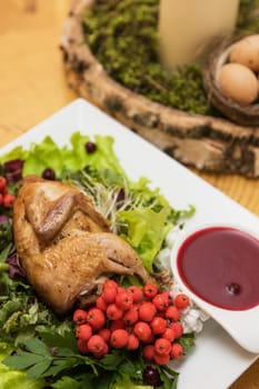 quail roasted with sweet and sour cranberry sauce decorated with rowanberry
