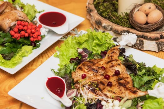 quail roasted with sweet and sour cranberry sauce decorated with rowanberry