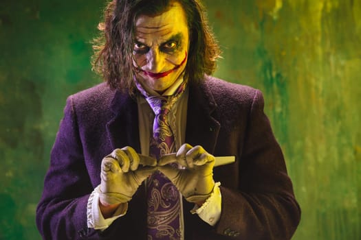 Bloody Halloween theme: The crazy maniak face on dark studio background