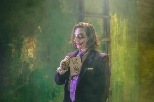 Bloody Halloween theme: The crazy maniak face on dark studio background