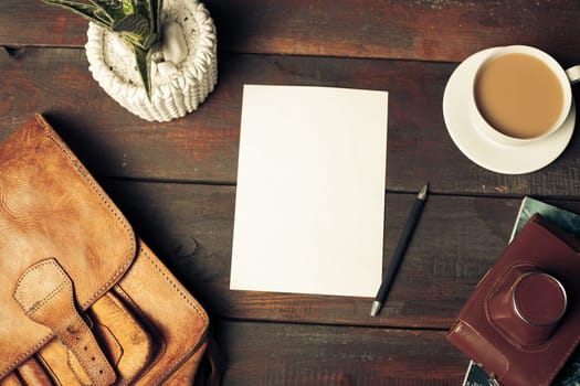 Opened craft paper envelope , autumn leaves and coffee on rustic wooden table