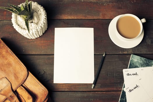 Opened craft paper envelope , autumn leaves and coffee on rustic wooden table