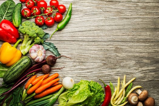 Various fresh vegetables and ingredients on wooden rustic background