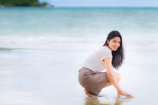 Beautiful Asian woman vacation on beach of Thailand.