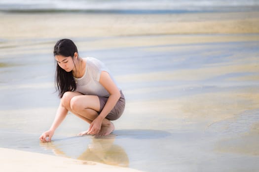 Beautiful Asian woman vacation on beach of Thailand.