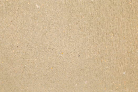 Closeup of sand pattern of a beach in the summer