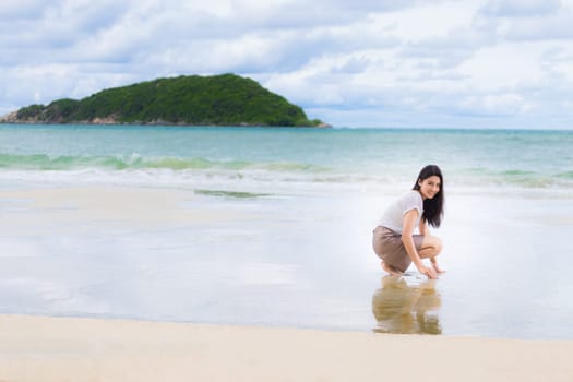 Beautiful Asian woman vacation on beach of Thailand.