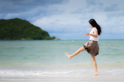 Beautiful Asian woman vacation on beach of Thailand.