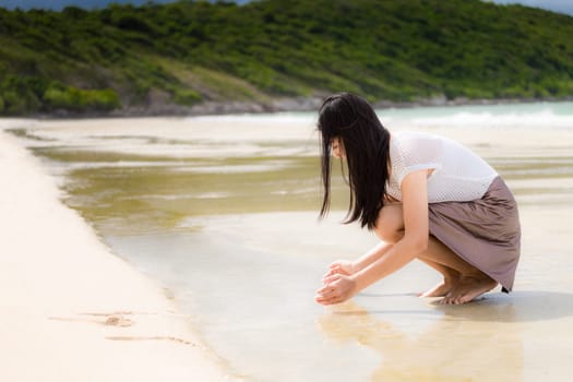 Beautiful Asian woman vacation on beach of Thailand.