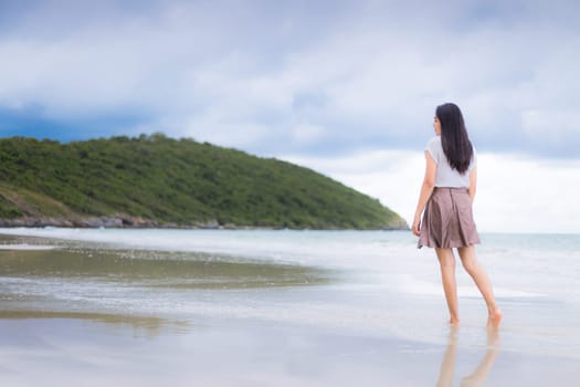 Beautiful Asian woman vacation on beach of Thailand.