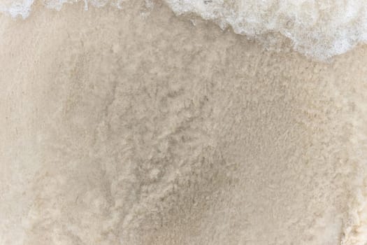 Closeup of sand pattern of a beach in the summer