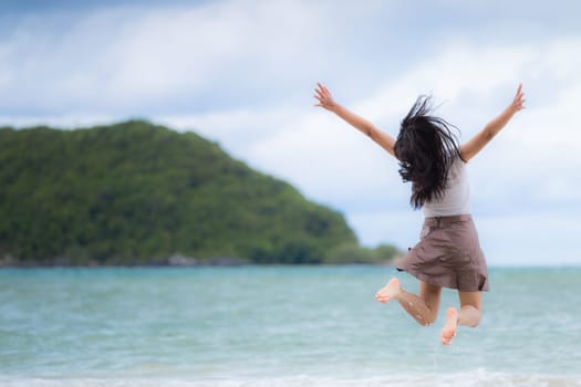 Beautiful Asian woman vacation on beach of Thailand.