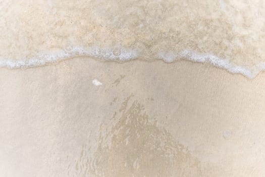 Closeup of sand pattern of a beach in the summer