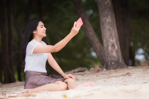Beautiful Asian woman vacation on beach of Thailand.