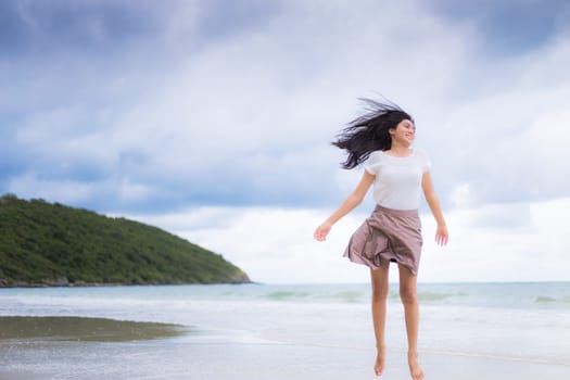 Beautiful Asian woman vacation on beach of Thailand.