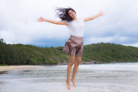 Beautiful Asian woman vacation on beach of Thailand.