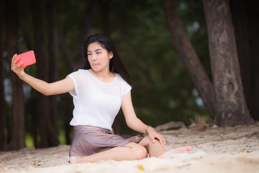 Beautiful Asian woman vacation on beach of Thailand.