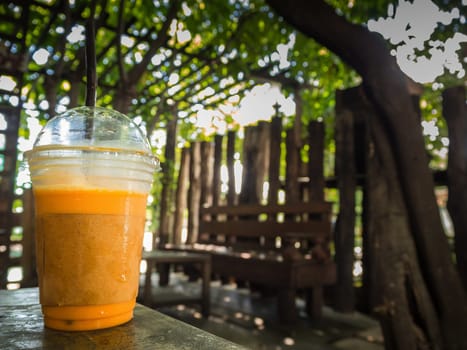 Iced milk tea or Thai milk tea on the table in the cafe.