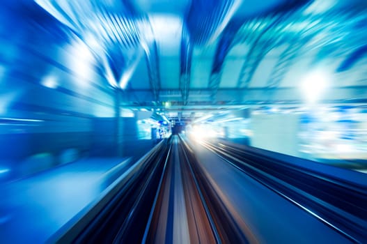 High speed train entering station platform. Focus on the rail road.