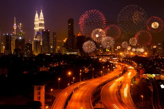 The capital of Malaysia, Kuala Lumpur city skyline night view with fireworks over the sky.
