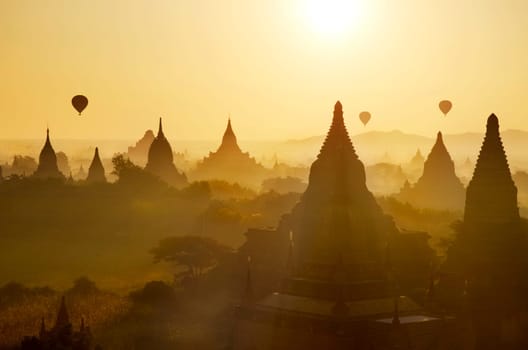 Sunrise at Bagan with hot air balloons, Myanmar, Asia.