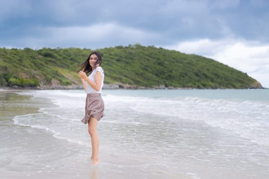Beautiful Asian woman vacation on beach of Thailand.