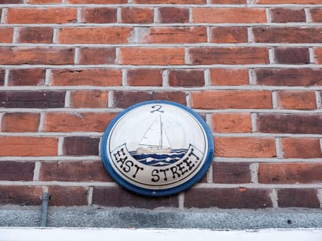 interesting boat street sign house number on wall  essex  england  uk