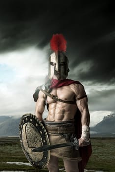 Ancient warrior or Gladiator posing outdoors with helmet