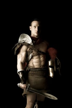 Ancient warrior or Gladiator posing over a dark background