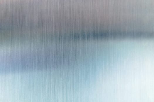 Convex polished shiny steel metal surface with colored reflections and glare.