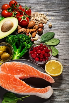 Mixed fresh healthy food with salmon fish- heart concept