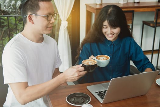 Business online concept. Asian friends meeting, drinking and having fun at coffee shop.