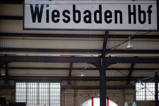 Wiesbaden,Germany - October 15,2017: The sign Wiesbaden Hauptbahnhof below the roof structure of the building on October 15,2017 in Wiesbaden.