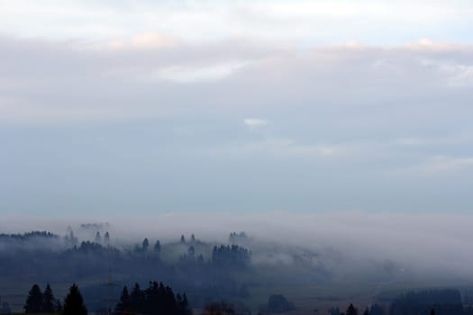 Autumn fog in Bavaria. In autumn,the fog moves over the landscape in the evening