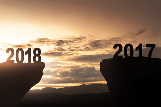 Happy New Year 2018 and Goodbye 2017 over sunset background