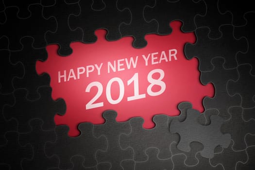 Happy New Year 2018 text on jigsaw puzzle with red background
