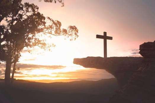 Jesus christ on the top of cliff over sunset background