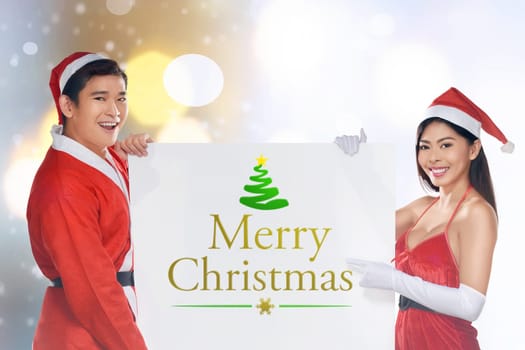 Asian couple wearing santa costume holding banner. Merry christmas concept