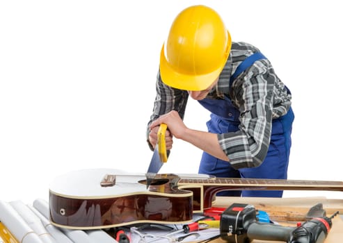 young worker plays music with a saw and a guitar