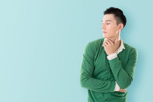 Sensitive Asian young man, closeup portrait with colorful background.